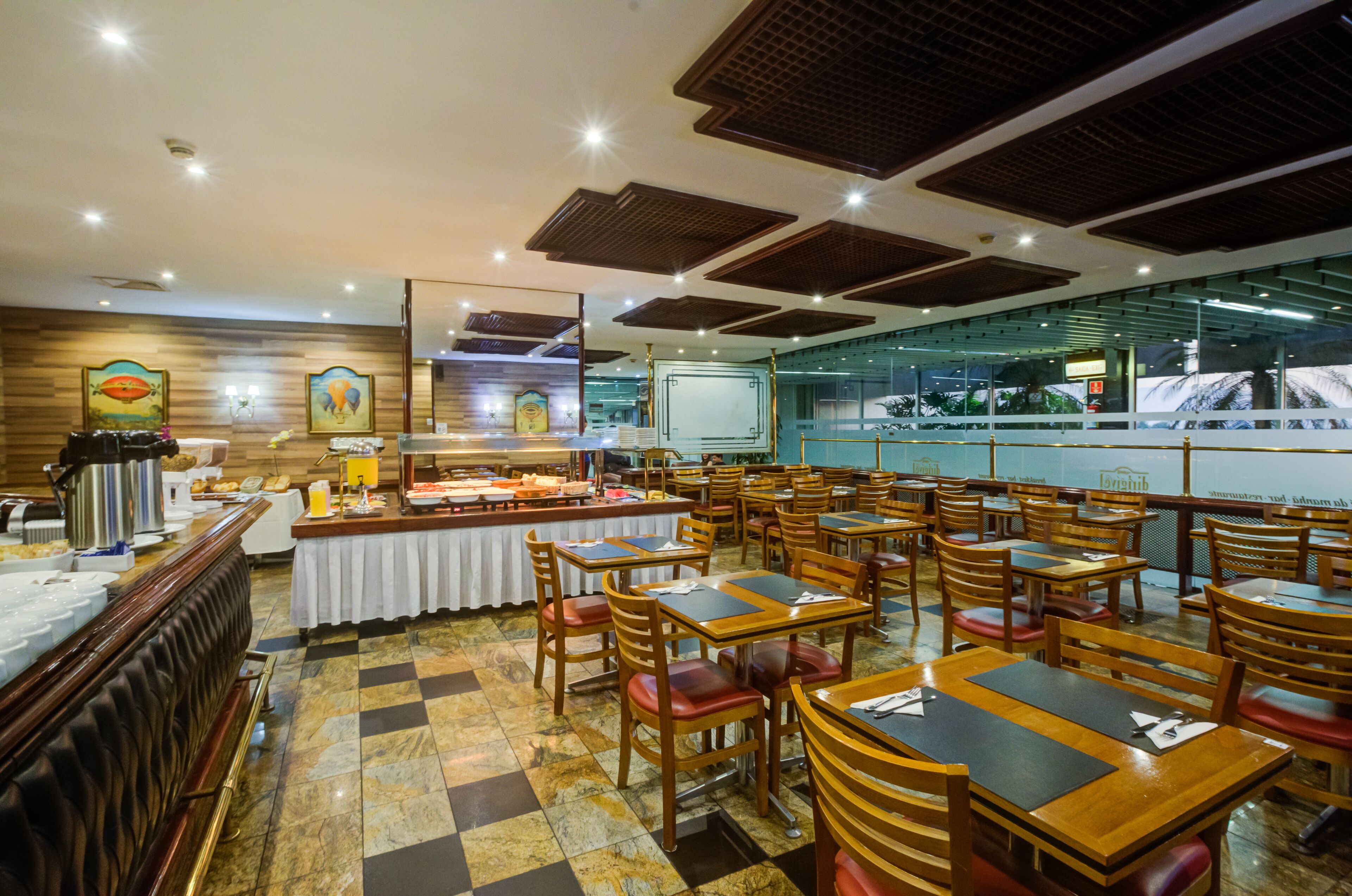 A buffet setup with a variety of food items and a seating area with tables and chairs.