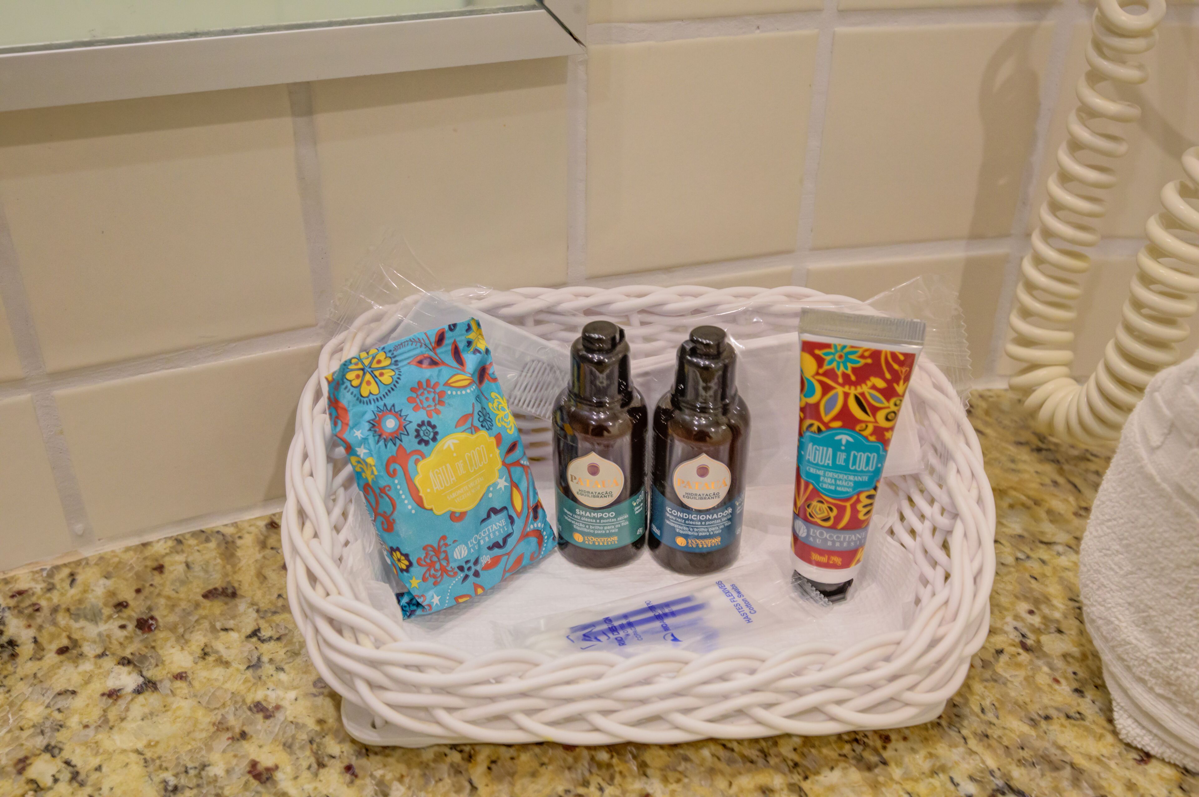 A basket containing toiletries on a kitchen counter.