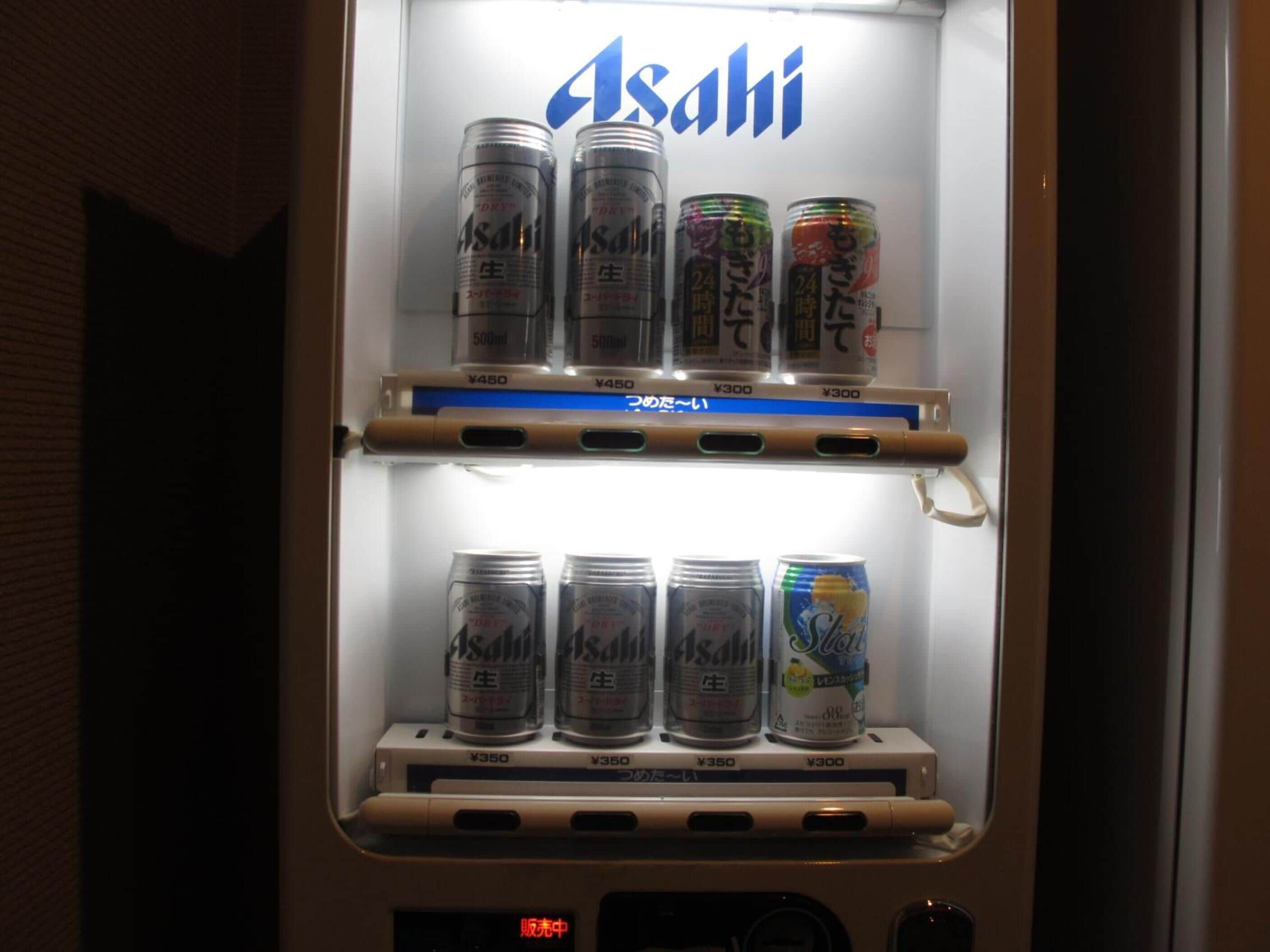 A vending machine stocked with Asahi beer cans.