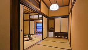 A traditional Japanese room with tatami flooring, sliding doors, and a low ceiling. - Nikko Tokino Yuu (Nikko)