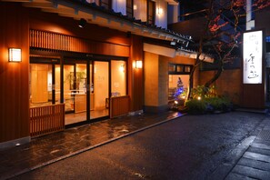 A traditional Japanese building with a wooden facade, a covered entrance, and a small Christmas tree decoration. - Nikko Tokino Yuu (Nikko)