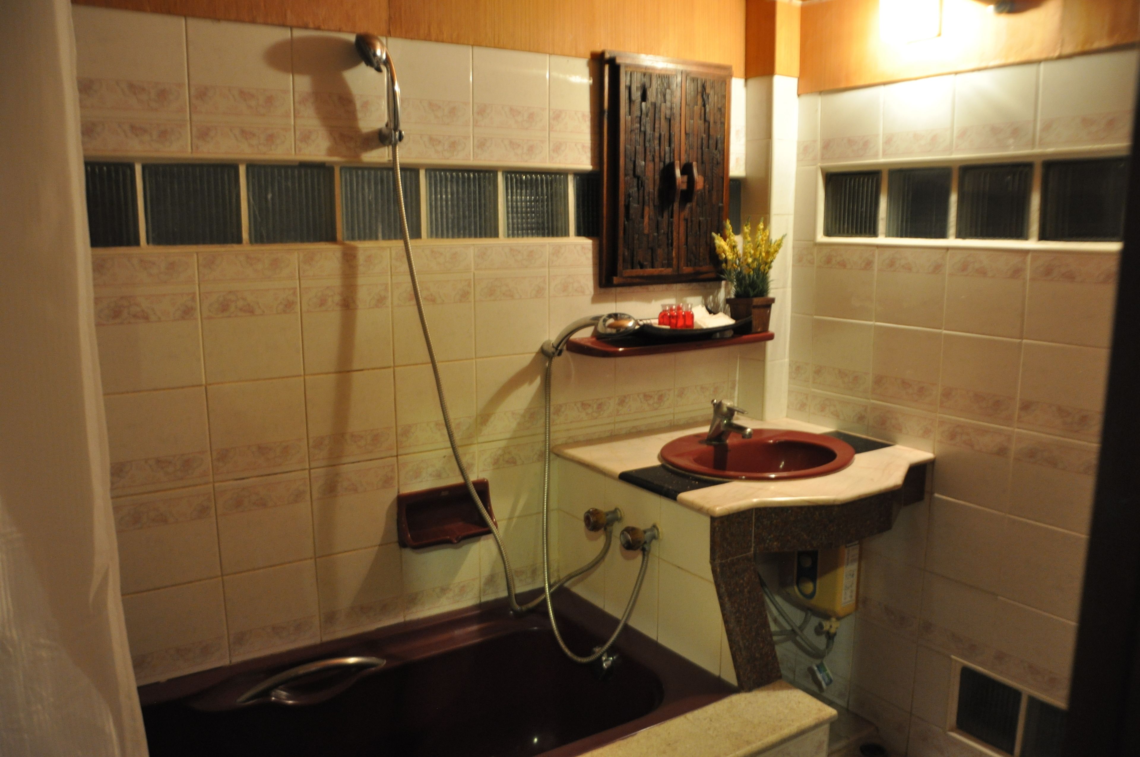 A bathroom with a bathtub, a sink, and a shower.