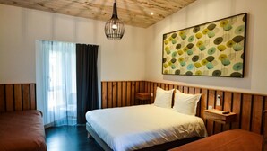 A hotel room with a wooden headboard, a large bed with white bedding, a bedside table with a lamp, and a large window with sheer curtains. - Le Relais Du Boisniard (Chanverrie)