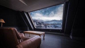 A room with a large window offering a view of a snowy mountain range. - Mizno Hotel (Fujikawaguchiko)