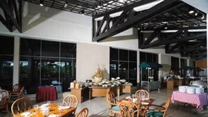 A spacious indoor dining area with high ceilings, large windows, and modern furniture. - RHR Hotel at Uniten (Kajang)