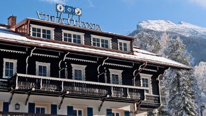 Villa Orania, a traditional Alpine-style building with multiple balconies and a sign indicating it is a hotel. - Villa Orania (Bad Gastein)