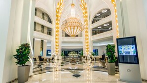 A spacious lobby with a grand chandelier, multiple seating areas, and a reception desk. - La Cigale Tabarka Hôtel Spa & Golf (Tabarka)