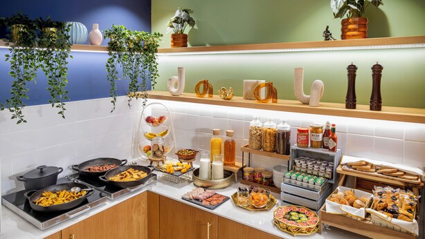 A buffet with various food items and condiments.