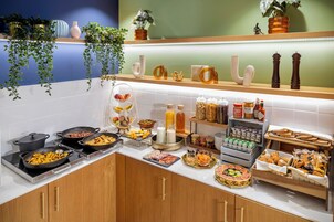 A buffet with various food items and condiments.