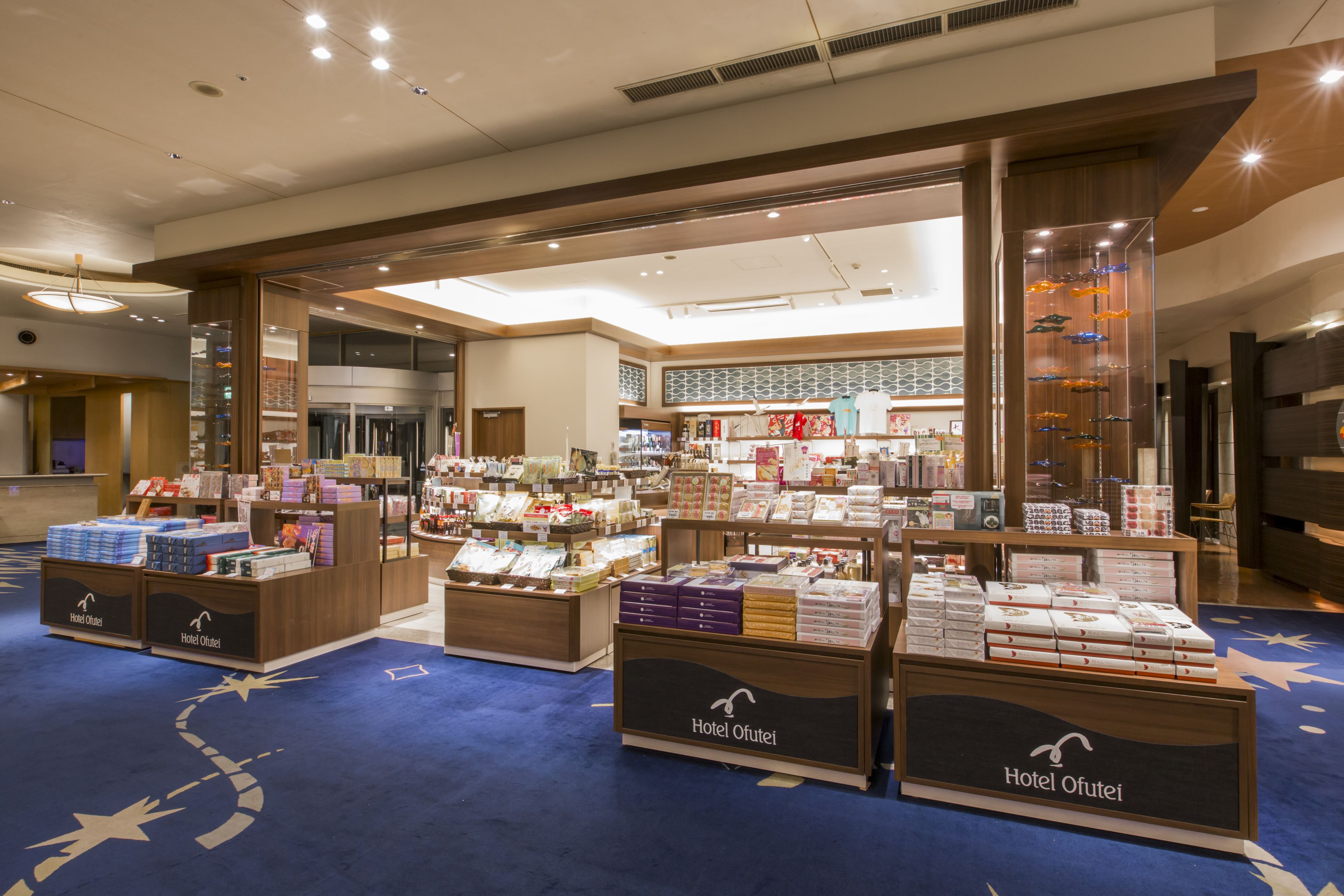 A hotel lobby with a display of various products and a reception area.
