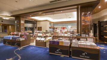 A hotel lobby with a display of various products and a reception area.