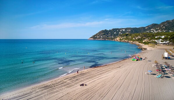 On the beach, sun loungers, beach umbrellas, beach towels
