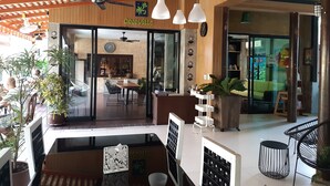 A restaurant interior with a wooden ceiling, hanging pendant lights, and a visible menu board. - Cocoville Phuket Resort (Chalong)