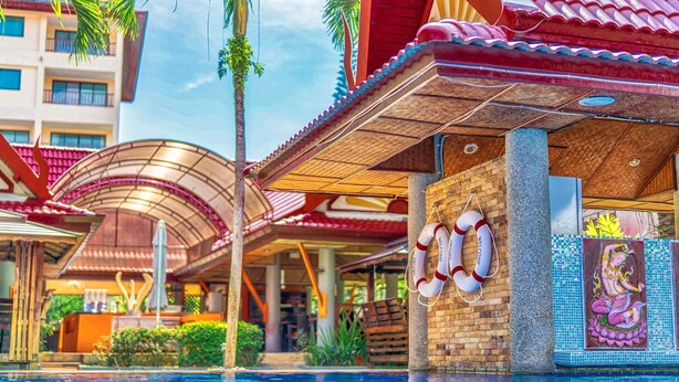A hotel with a swimming pool, a lifebuoy, and a mural of a mythological figure. - Sai Rougn Residence (Patong)