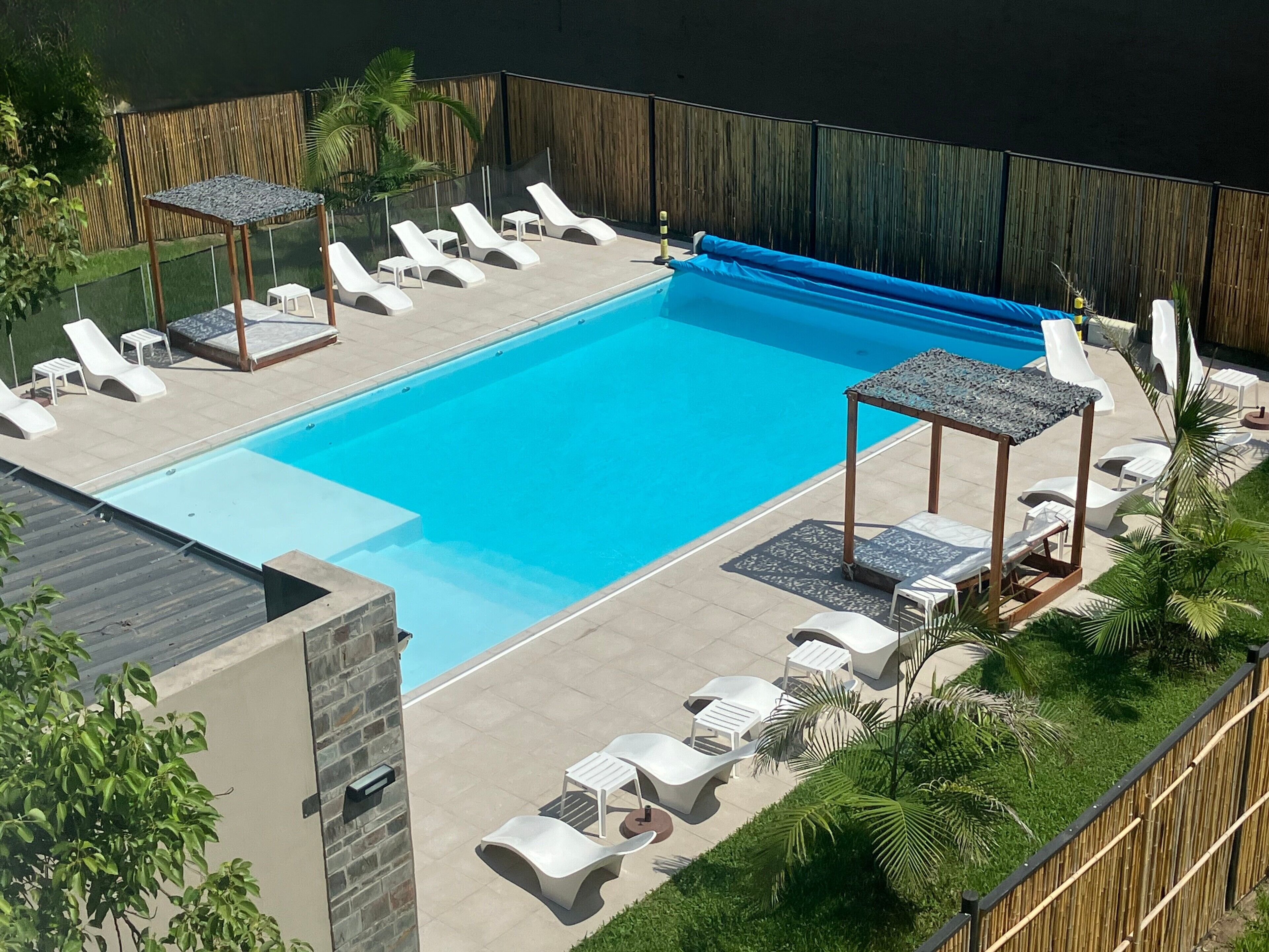 Outdoor pool, open 10 AM to 9 PM, pool umbrellas, pool loungers