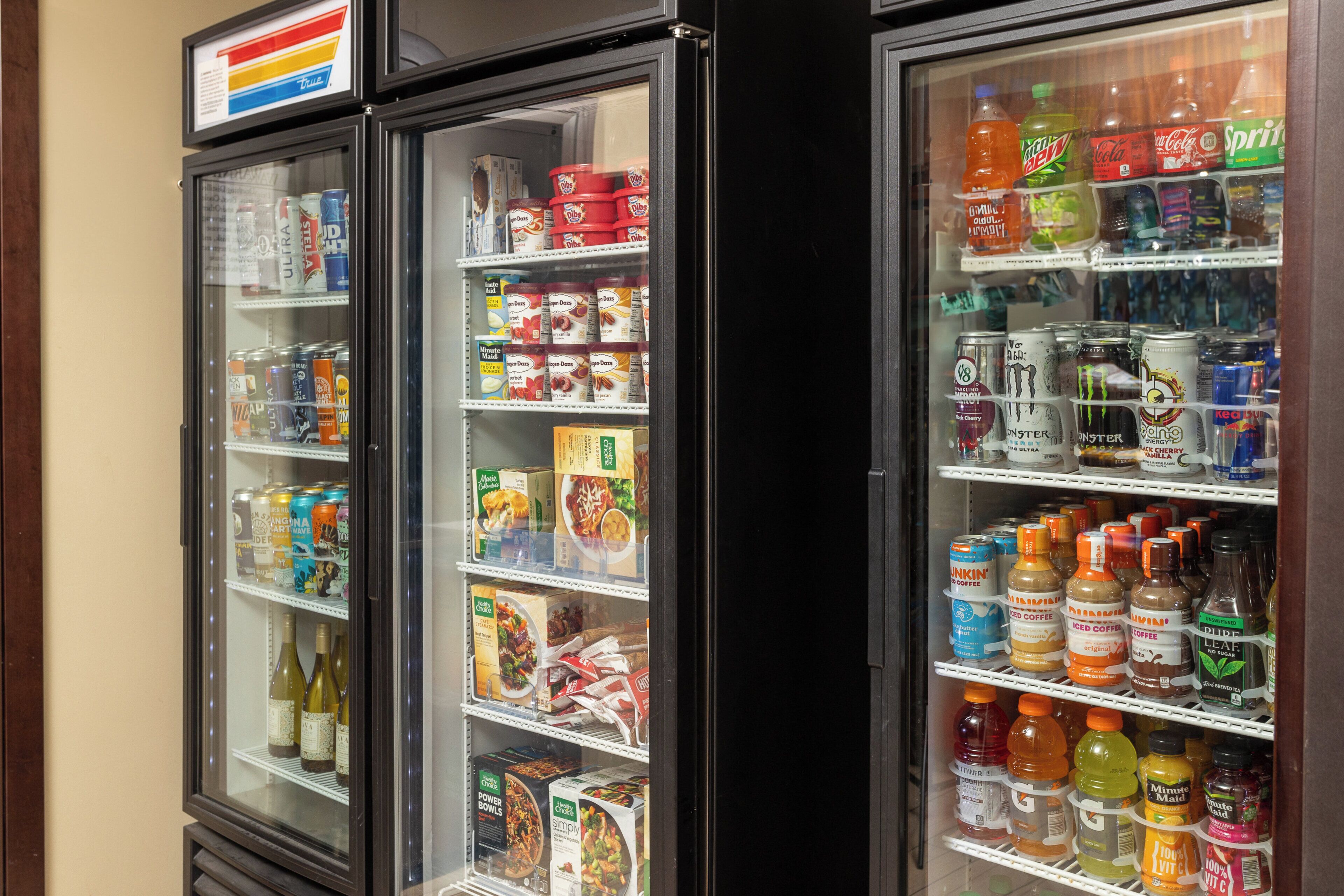 Two refrigerated display cases stocked with various beverages and food items.