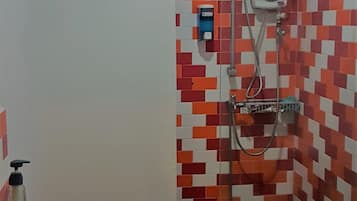 A bathroom with a shower, a sink, and a toilet.