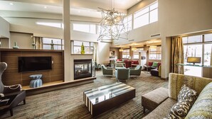 A spacious hotel lobby with a modern fireplace, comfortable seating, and large windows allowing natural light. - Residence Inn Harlingen (Harlingen)