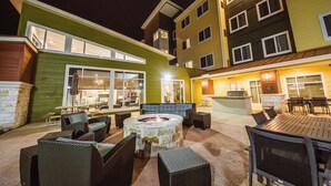An outdoor patio area with a fire pit, seating, and a bar area. - Residence Inn Harlingen (Harlingen)