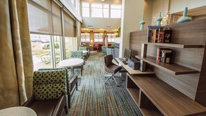 A hotel lobby with a seating area, a computer desk, and a bookshelf. - Residence Inn Harlingen (Harlingen)