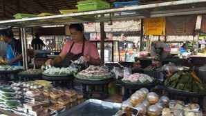 A food stall with various dishes displayed on trays and in containers. - Seabox Khaolak Hostel (Takua Pa)