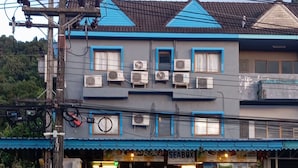A two-story building with a blue awning, air conditioning units, and a sign for 'SEABOX'. - Seabox Khaolak Hostel (Takua Pa)