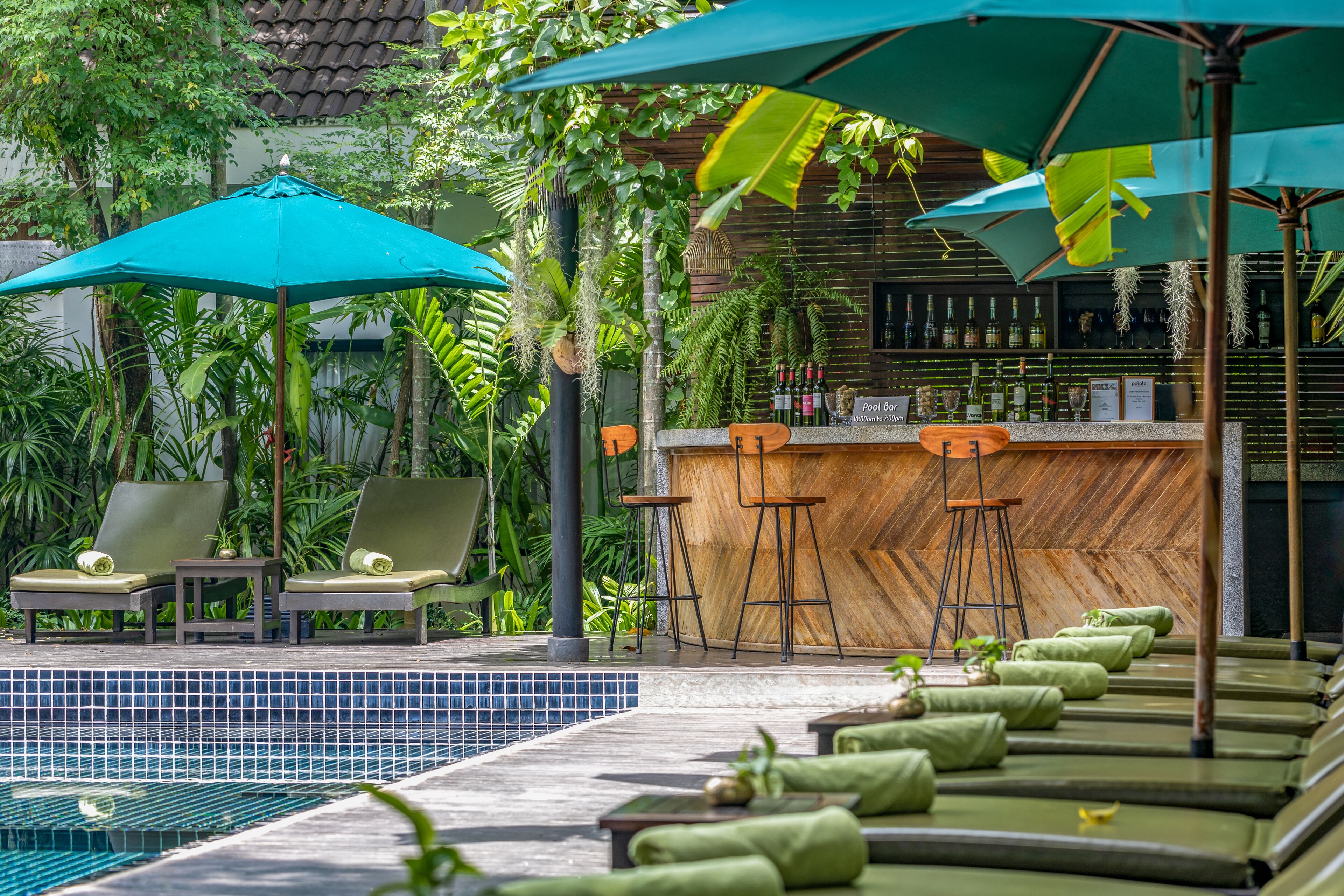 outdoor pool, open 8:00 am to 7:00 pm, pool umbrellas, pool loungers