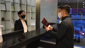 A reception area with a black counter, framed certificates on the wall, and a glass display case. - Jade Hotel & Suites (Makati)
