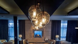 A modern conference room with a long wooden table, comfortable seating, and a large chandelier. - Courtyard by Marriott Walla Walla (Walla Walla)