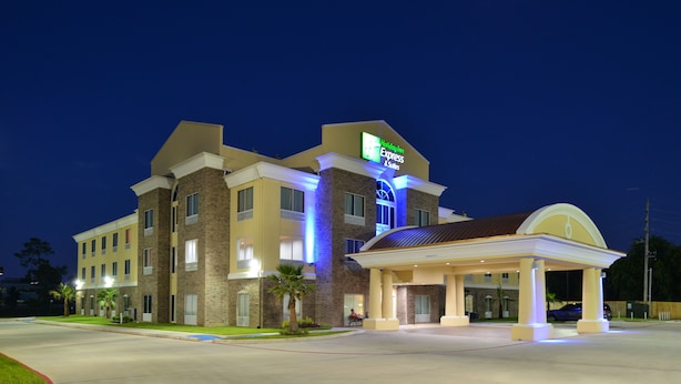 A hotel with a prominent sign, a covered entrance, and a well-lit facade.