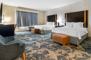A hotel room with two beds, a desk, a chair, and a large window with curtains. - Hampton Inn Marion (Marion)