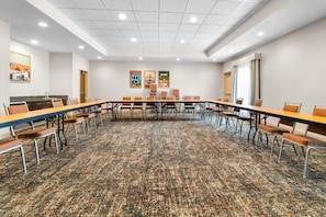 A conference room with a long table, chairs, and a carpeted floor. - Hampton Inn Marion (Marion)