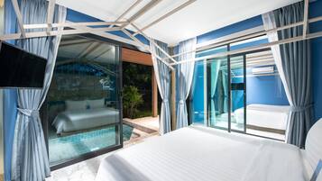 A modern hotel room with a large bed, a glass door leading to a pool, and a view of the outdoors.