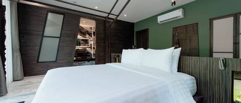 A modern bedroom with a large bed, wooden paneling, and a built-in wardrobe.