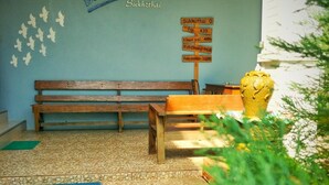 A blue wall with a wooden bench and a signboard. - Blue House Sukhothai (Sukhothai)