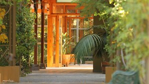 A wooden structure labeled "Spa Termina" with a pathway leading to it, surrounded by greenery and potted plants. - Termas Jahuel Hotel & Spa (Santa Maria)