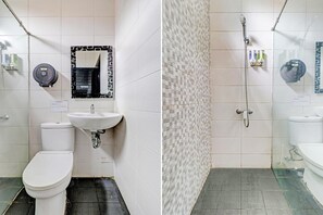 A bathroom with a toilet, sink, and shower. - D'River Guesthouse (Bandung)
