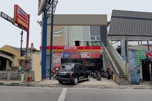 A commercial area with an Alfamart store, a pharmacy, and a small shop. - D'River Guesthouse (Bandung)