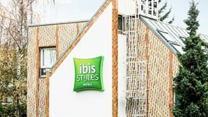 A modern building with a green sign reading 'ibis Styles Hotel.' - ibis Styles Paris Velizy (Velizy-Villacoublay)