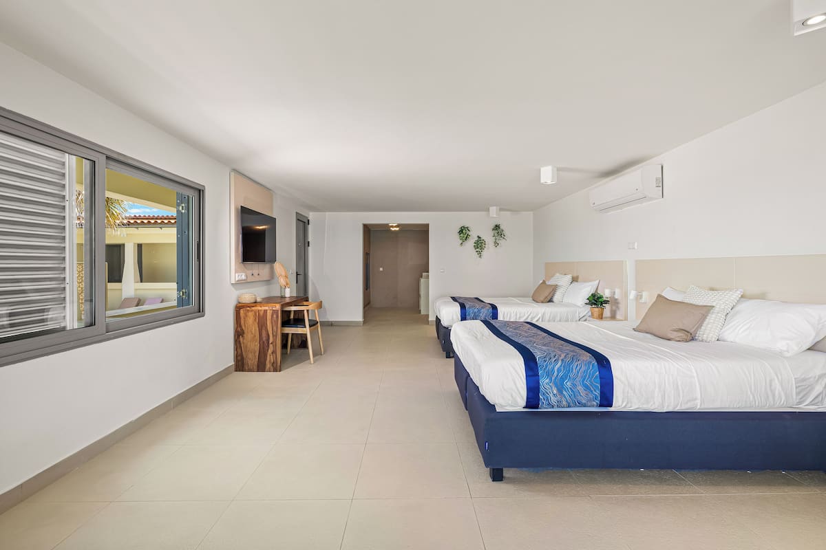 deluxe quadruple room | 1 bedroom, premium bedding, in-room safe, blackout curtains