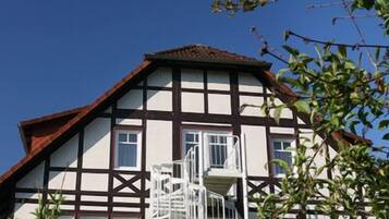 Traditional building with a steeply pitched roof and central staircase.