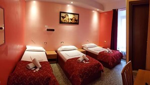 A hotel room with three single beds, a painting on the wall, and a window with curtains. - Legend R. G. (Rome)