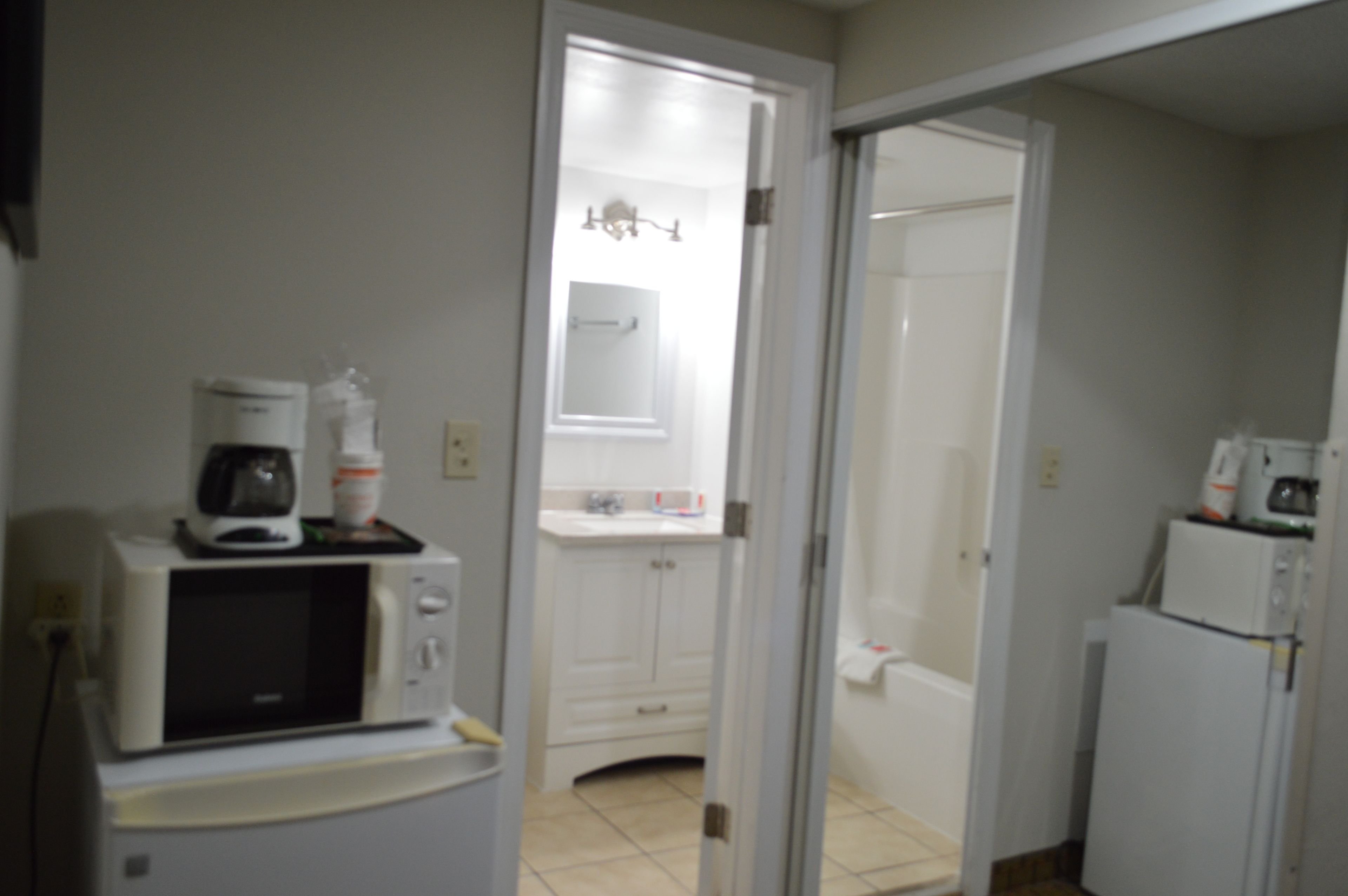 standard room, 2 queen beds, patio, river view | bathroom | combined shower/bathtub, hair dryer, towels