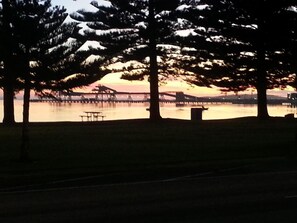 A park with trees, a picnic table, and a bridge in the background. - Grand Tasman Hotel (Port Lincoln)