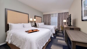 A hotel room with two beds, a desk, and a television. - Hampton Inn Broussard-Lafayette Area (Broussard)