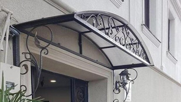 An entrance with a covered patio, potted plants, and outdoor seating. - Classic Hotel Tbilisi (Tbilisi)