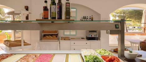 A buffet area with various food options and a selection of beverages.