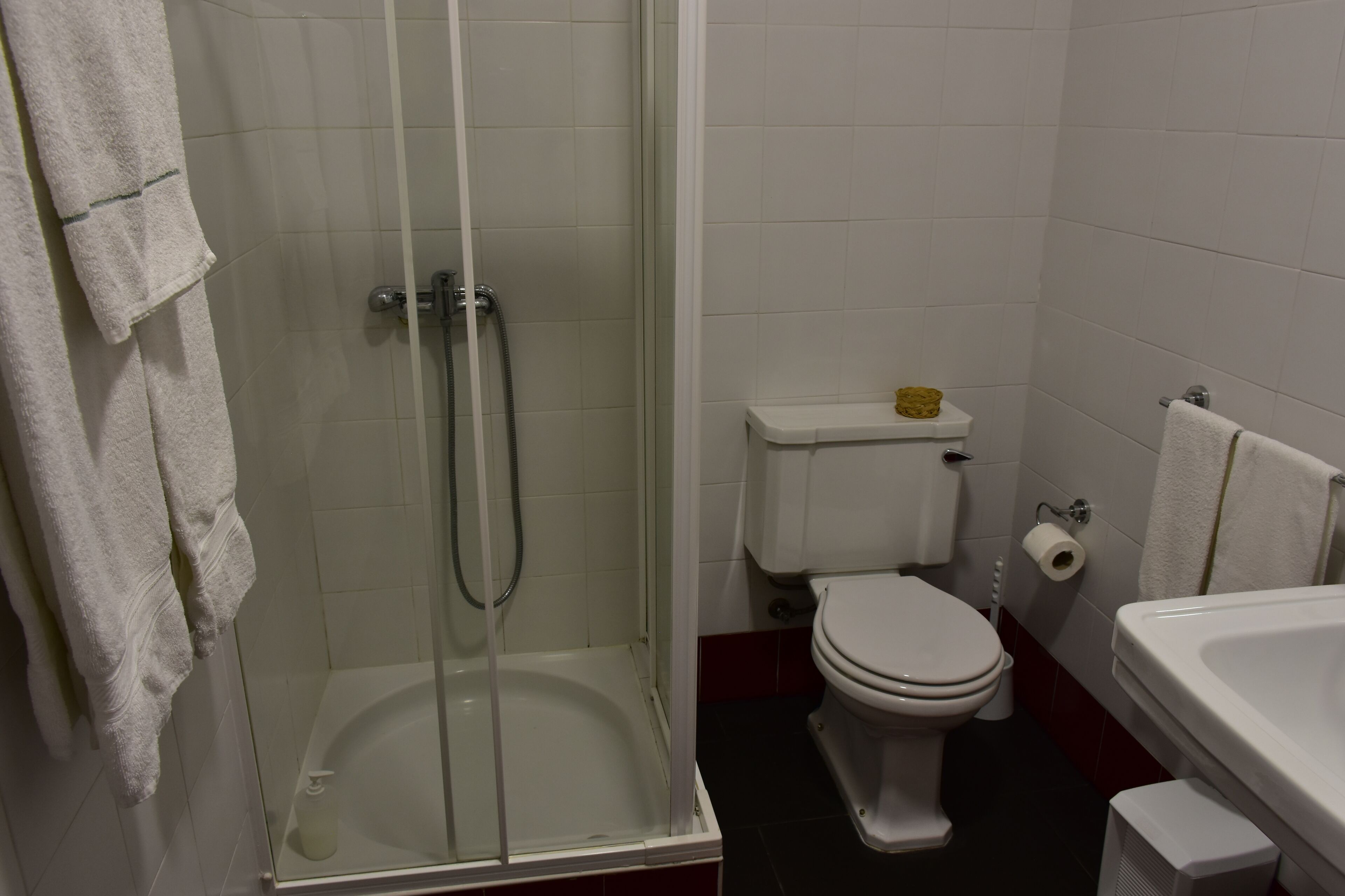 A bathroom with a glass-enclosed shower, a toilet, and a bathtub.