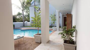 Outdoor pool, open 6:00 AM to 9:30 PM, pool loungers