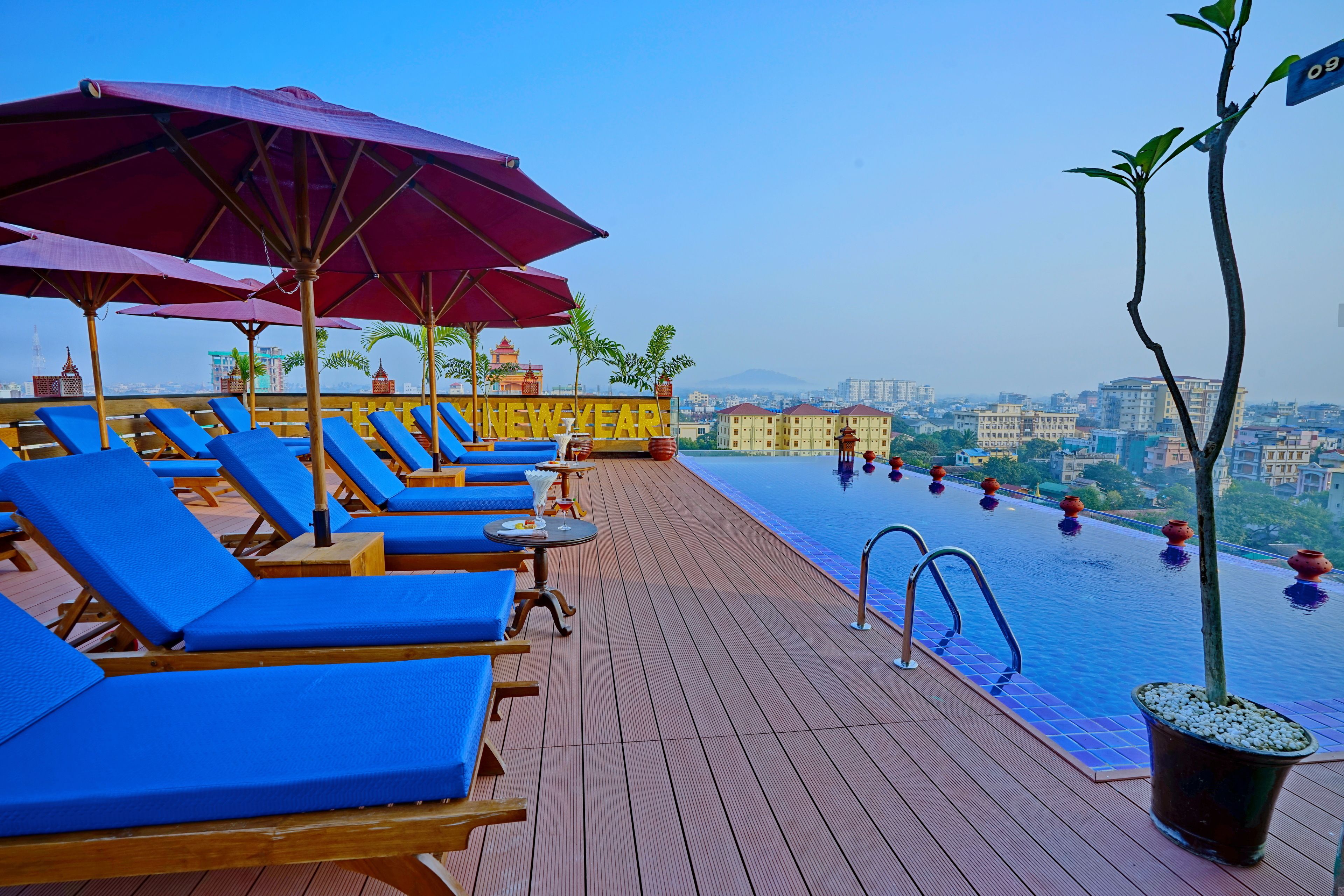 outdoor pool, open 9:00 am to 8:00 pm, pool umbrellas, pool loungers